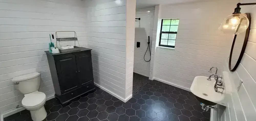 Renovated bathroom with shiplap and black fixtures by BNB Concepts