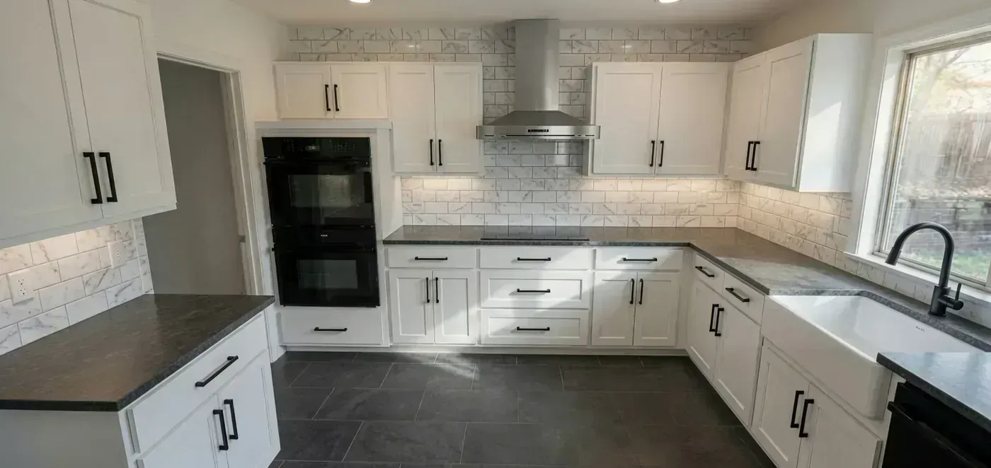 Remodelled kitchen with marble backsplash and farmhouse sink by BNB Concepts