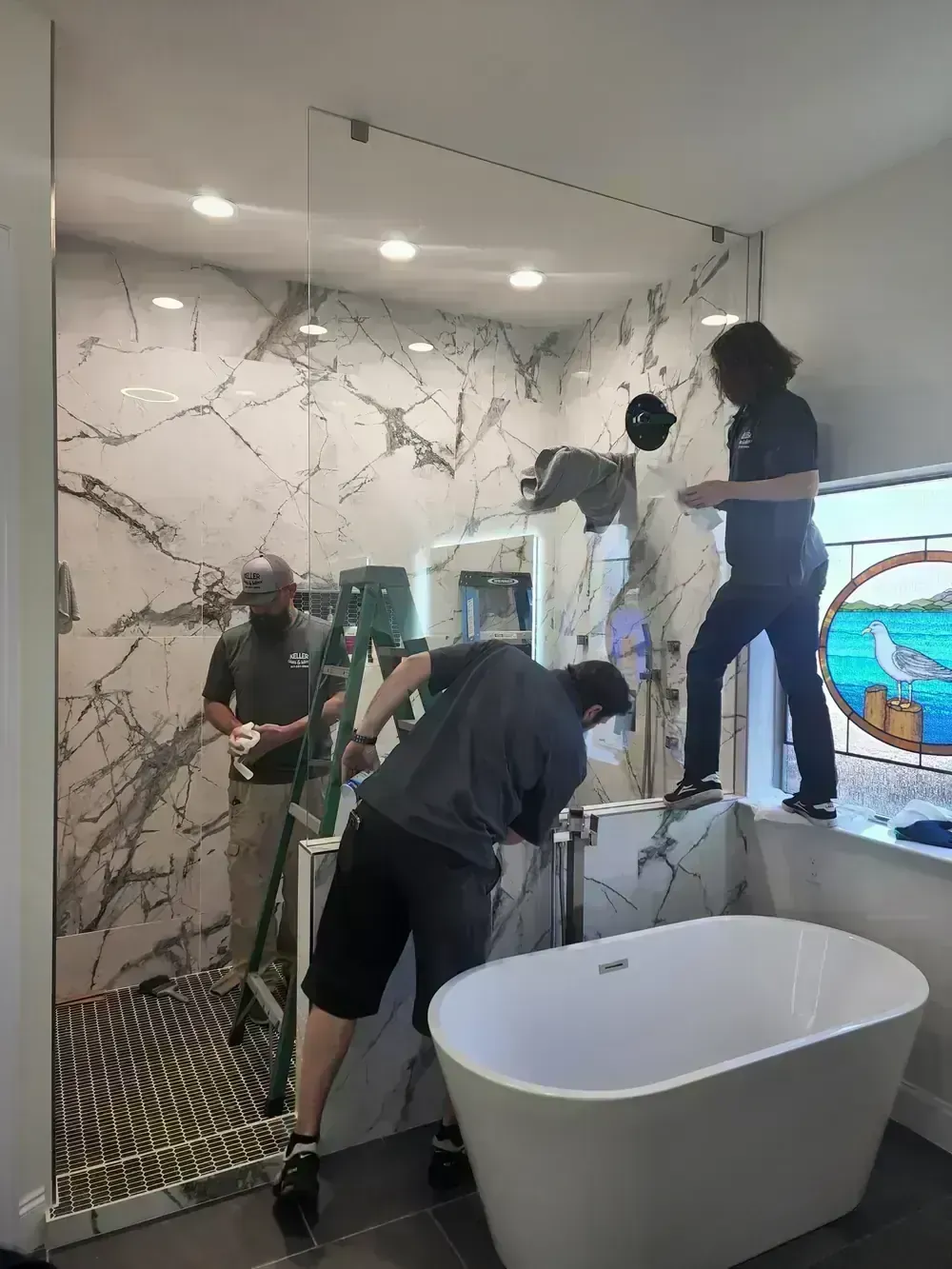 BNB Concepts crew installing a frameless glass shower enclosure