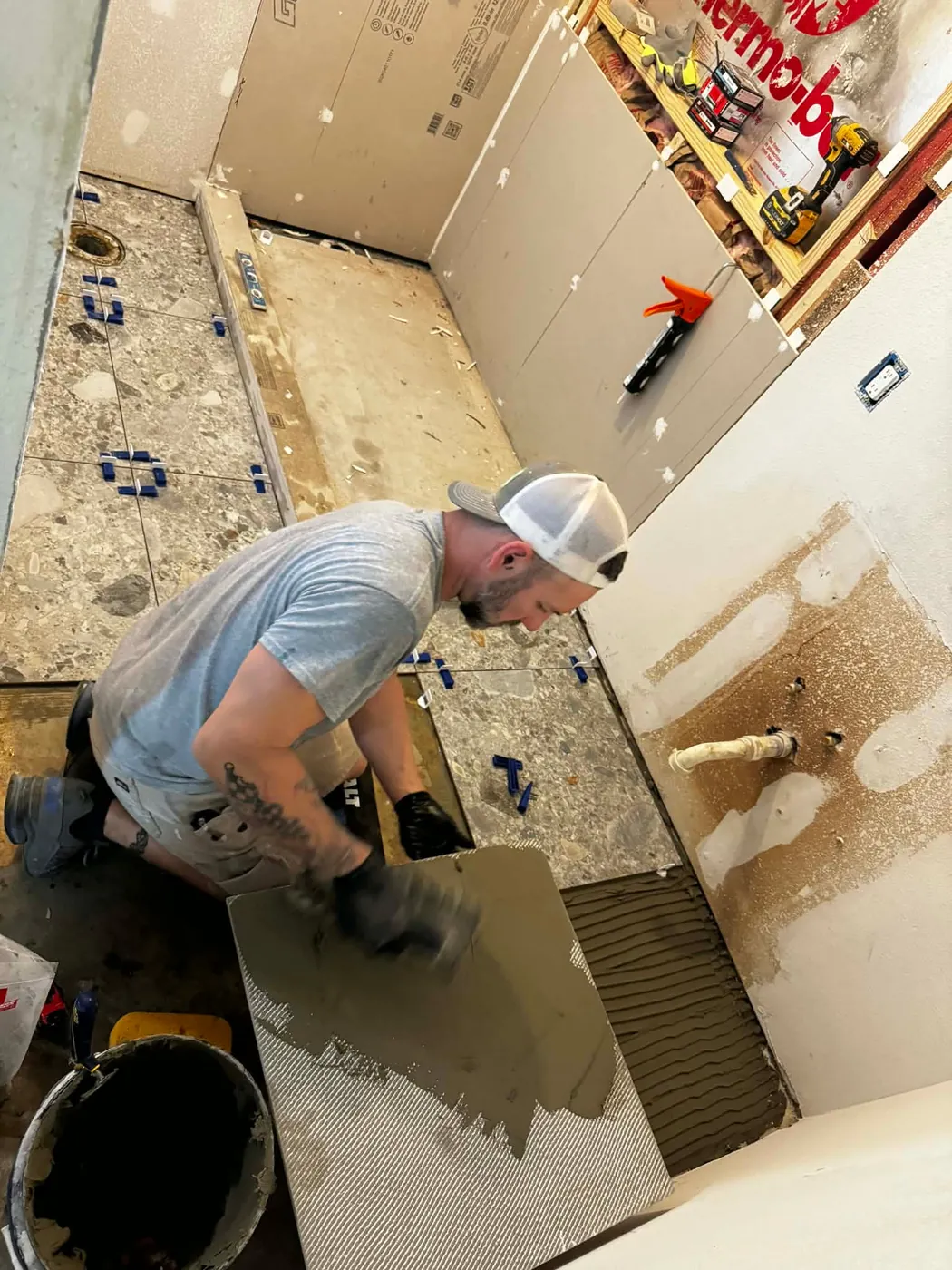 John McNatt spreading thin-set for a tile floor