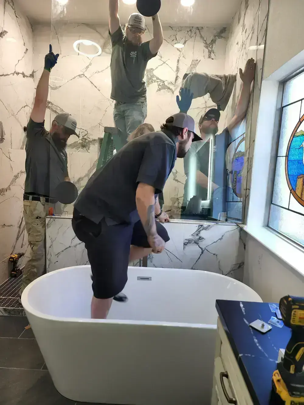 Crew setting marble slab around a freestanding tub